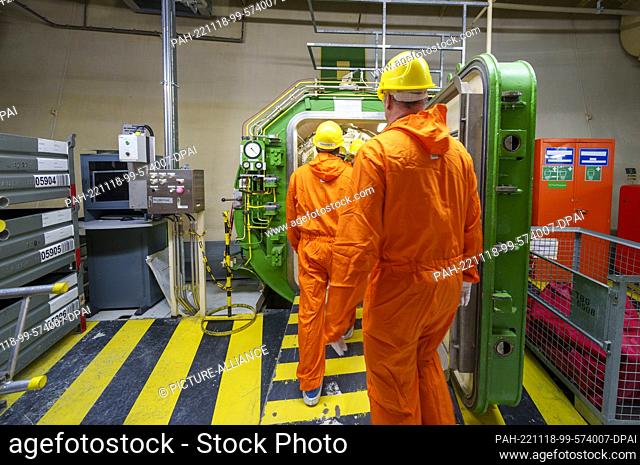 18 November 2022, Hessen, Biblis: People walk through an airlock in a power plant unit. The Biblis nuclear power plant has been undergoing decommissioning since...