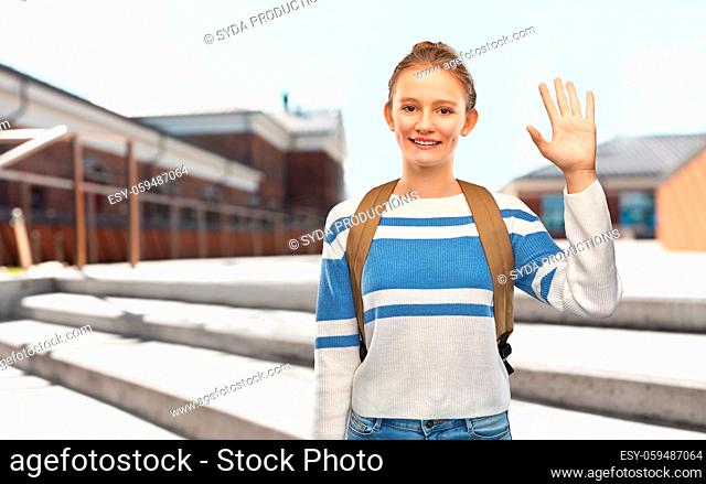 smiling teenage student girl with school bag
