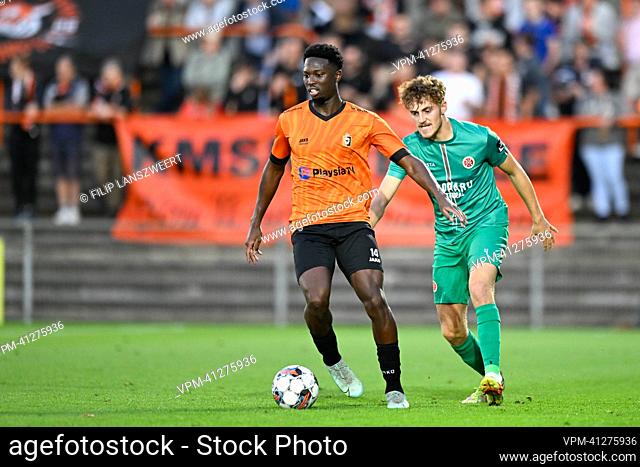 Deinze's Bafode Dansoko and Virton's Elias Spago fight for the ball during a soccer match between KMSK Deinze and Royal Excelsior Virton