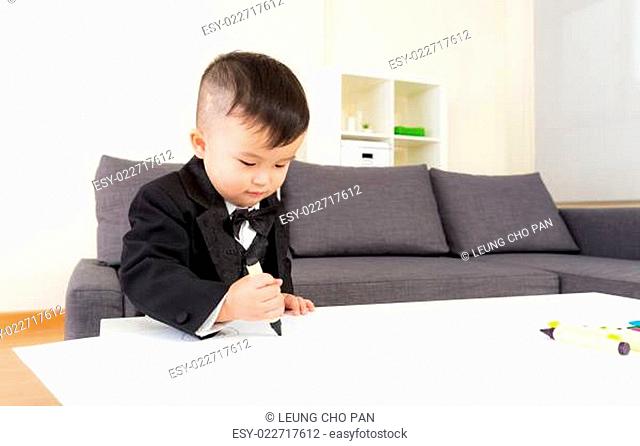 Little boy drawing at home