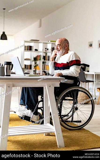 Disabled businessman attending video call through laptop at home