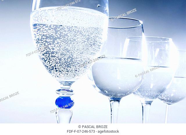 Close-up of four glasses of mineral water