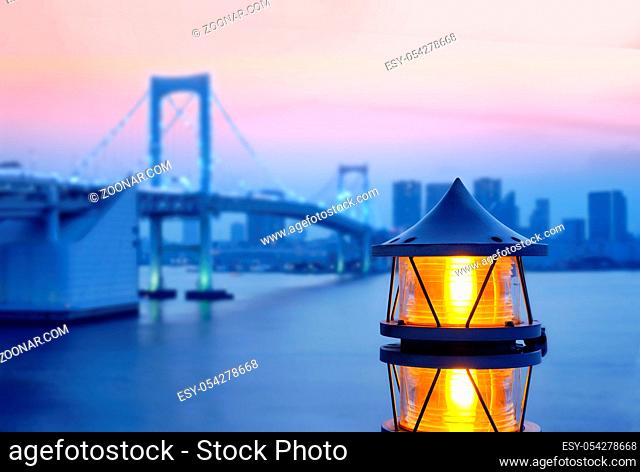 Lantern of the Rainbow Bridge on the bay of Odaiba with illuminations in sunset sky