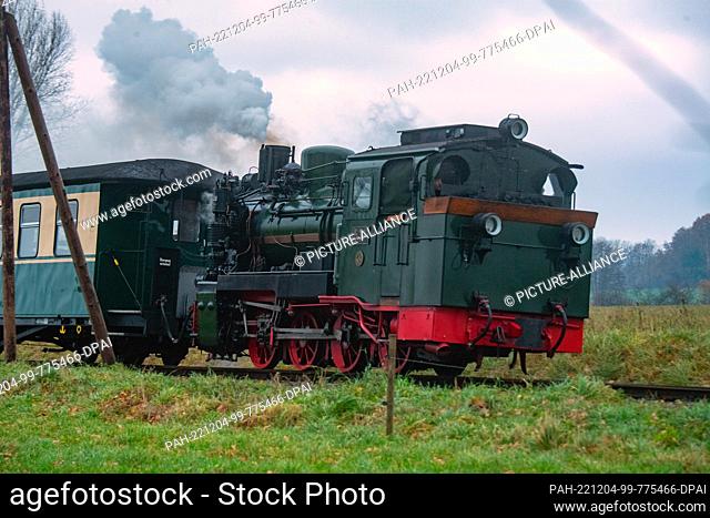 04 December 2022, Mecklenburg-Western Pomerania, Putbus: Steam locomotive 53 Mh (99 4633) of the small railroad ""Rasender Roland"" pulls a train across the...