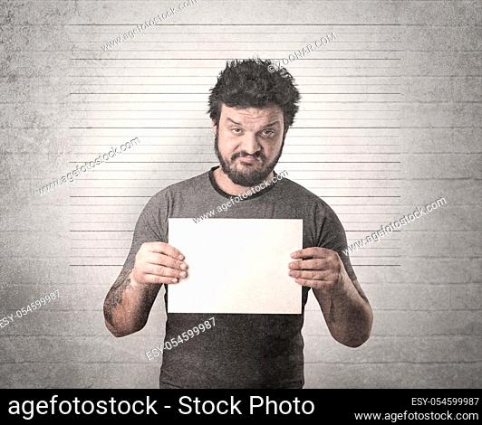 Gangster in front of a wall with table on his hand