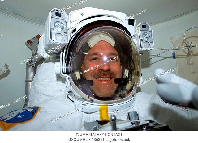 Astronaut John M. Grunsfeld, payload commander, has donned his extravehicular mobility unit (EMU) space suit and appears ready to begin the middle of five...