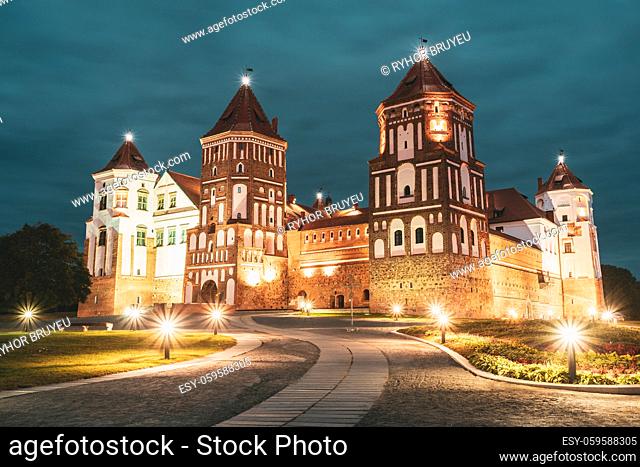 Mir, Belarus. Mir Castle Complex In Evening Night Illumination Lighting. Famous Landmark Under Blue Night Sky. UNESCO Heritage