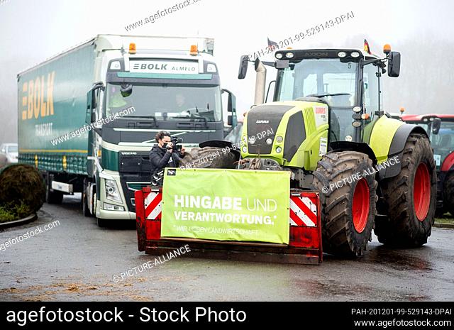 01 December 2020, Lower Saxony, Cloppenburg: A tractor, to which a banner with the inscription ""Dedication and Responsibility"" is attached