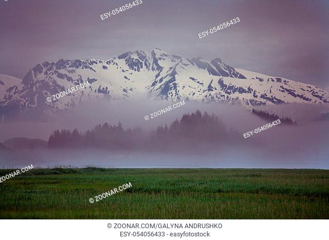 Picturesque Mountains of Alaska in summer. Snow covered massifs, glaciers and rocky peaks