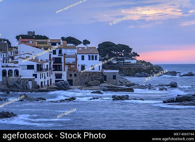 Blue hour and sunrise in the fishing village of Calella de Palafrugell, with its boats and white houses, on the Costa Brava coast (EmpordÃ , Girona, Catalonia
