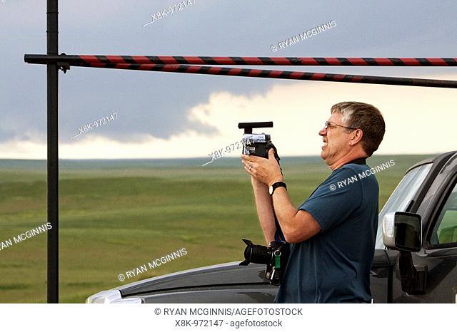 Storm chaser and journalist Phil Berg watches a distant wall cloud and supercell in Goshen County, Wyoming, June 5, 2009  Phile is participating in Project...