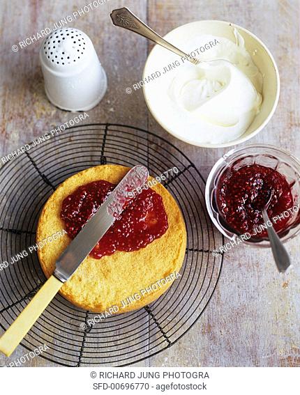 Spreading Strawberry Preserves Over Sponge Cake, Cream