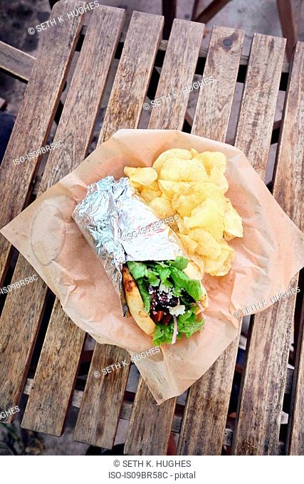 Meal of salad wrap and potato chips