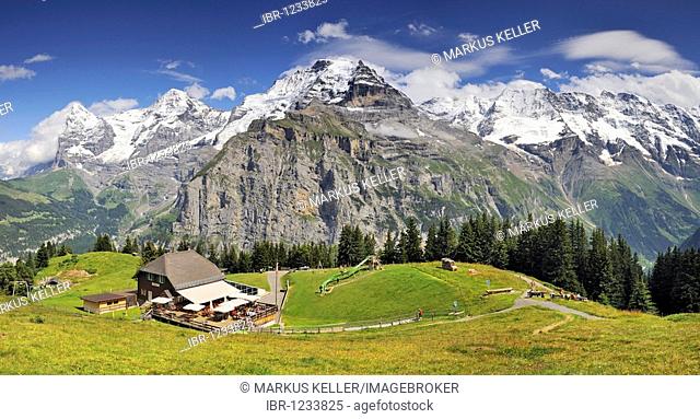 Panoramic view from Mt. Allmendhubel to the mountain inn and on the Eiger, Moench and Jungfrau mountains in the Bernese Oberland, Canton Bern, Switzerland