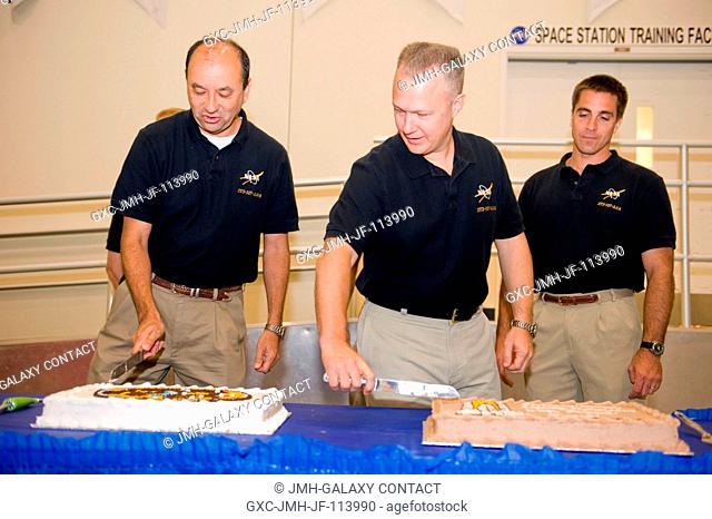 Astronauts Mark Polansky (left), STS-127 commander; Doug Hurley, pilot; and Christopher Cassidy, mission specialist, are pictured during a cake-cutting ceremony...