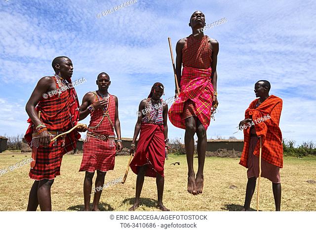 Young Maasai men performing a traditional jumping dance, Masai Mara National Reserve, Kenya