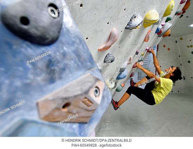 Student Leona Yinga makes her way up a climbing wall in 'Kletterthalia' bouldering centre of IG Klettern Halle/Loebejuen (Halle/Loebejuen climbing association)...