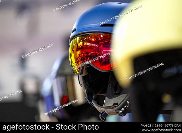 28 November 2023, Bavaria, Munich: Ski helmets and ski goggles are on display at the Scott stand during the ISPO sporting goods trade fair at Messe München