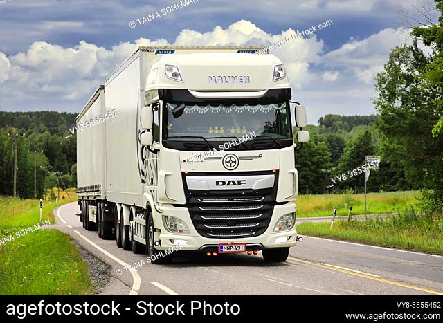 White DAF XF freight transport truck Malinen delivers load along highway 52 on a day of summer. Tenhola, Finland. July 24, 2020