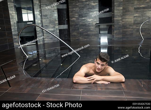 Front view of man smiling and relaxing in the spa