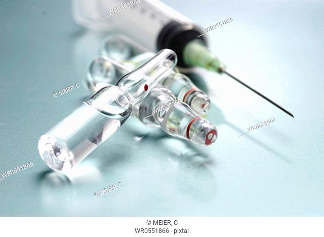 Three ampoules and a syringe