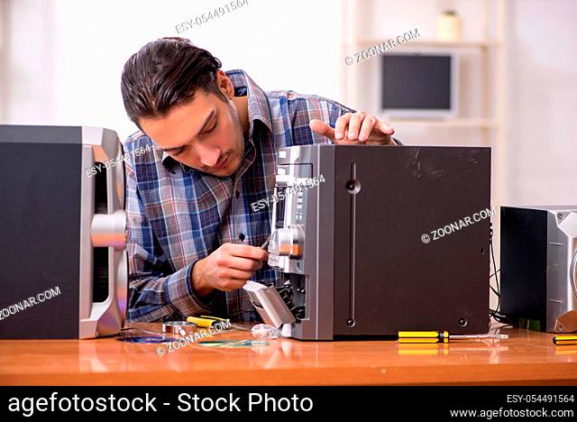 The young engineer repairing musical hi-fi system