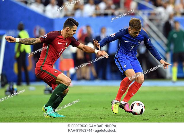 Antoine Griezmann (L) of France and Jose Fonte of Portugal vie for the ball during the UEFA EURO 2016 soccer Final match between Portugal and France at the...