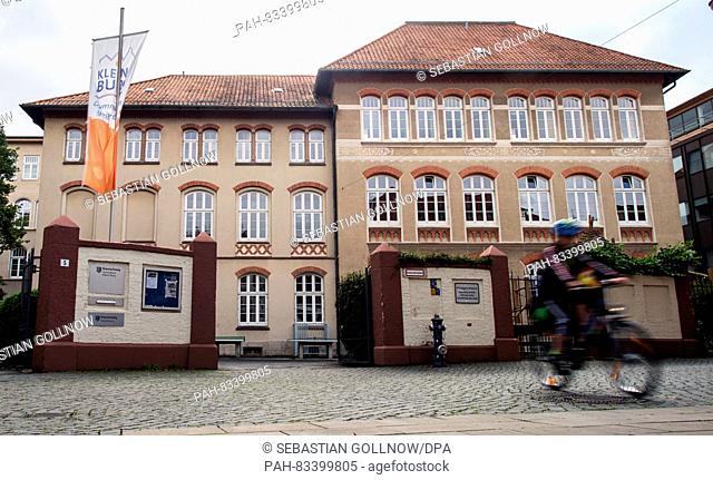 A boy rides a bike out of the Gymnasium Kleine Burg high school, closed due to attack threats, in Braunschweig, Germany, 05 September 2016