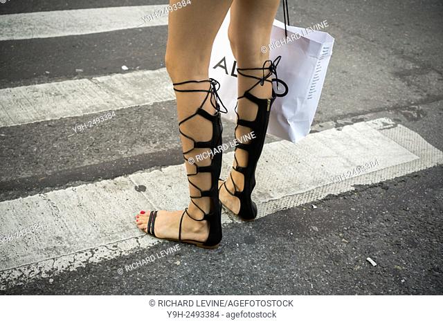 A woman wears this season's popular footwear, roman sandals, in New York