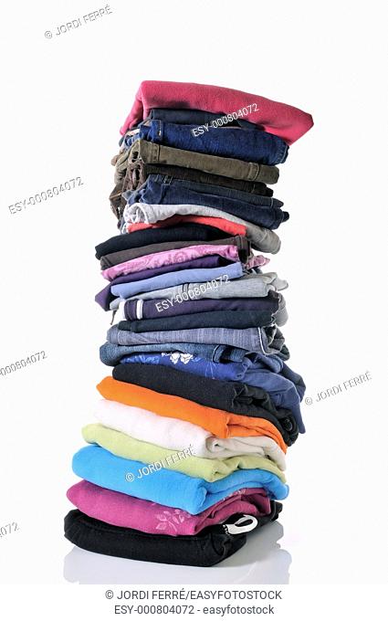 pile of folded clothes on white background