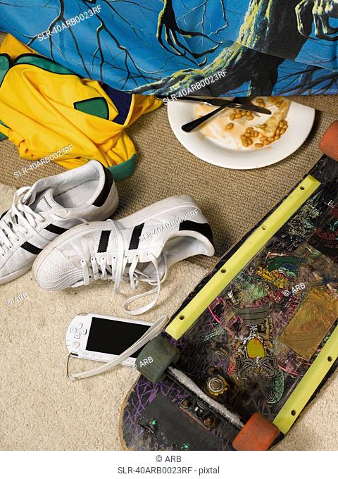 Cell phone and skateboard in bedroom