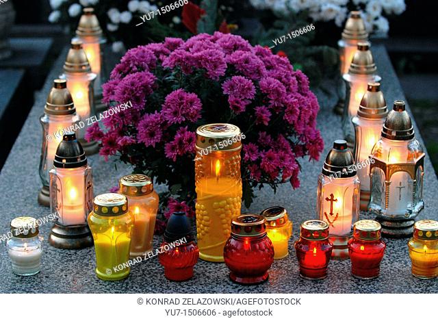 Chrysanthemums and candles on Wolski cemetery in Warsaw, Poland during All Saints Day