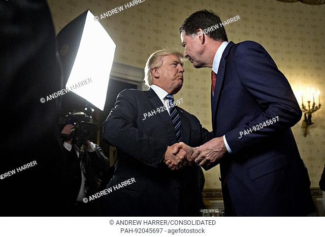 United States President Donald J. Trump, left, shakes hands with James Comey, director of the Federal Bureau of Investigation (FBI)
