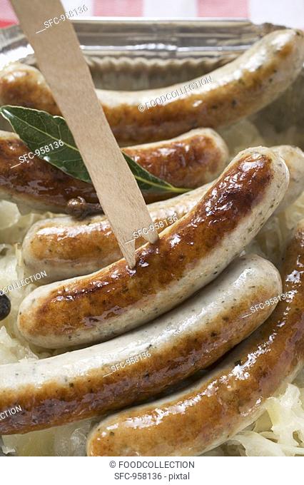 Sausages with sauerkraut in aluminium container to take away