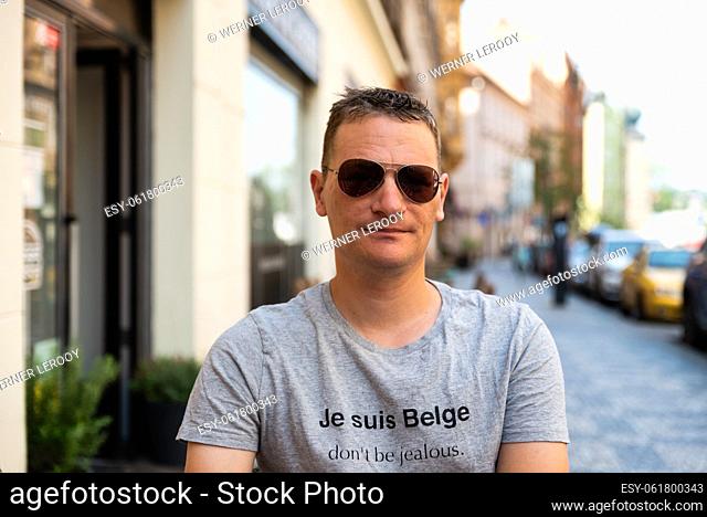 Prague Czech Republic Attractive forty year old man wearing sunglasses at a Prague cafe terrace