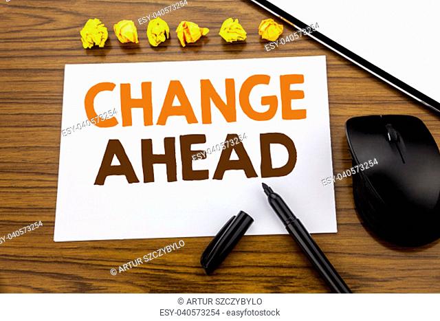 Conceptual hand writing text showing Change Ahead Red Word. Business concept for Future Changes written on sticky note paper on wooden background with marker...