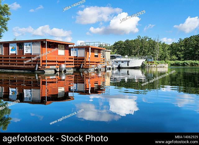 peenetal river landscape nature park, water hikers resting place and stolpe sports boat harbor, houseboats in the morning light