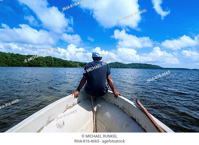 Man sitting on a boat near Nan Madol, Pohnpei Ponape), Federated States of Micronesia, Caroline Islands, Central Pacific, Pacific