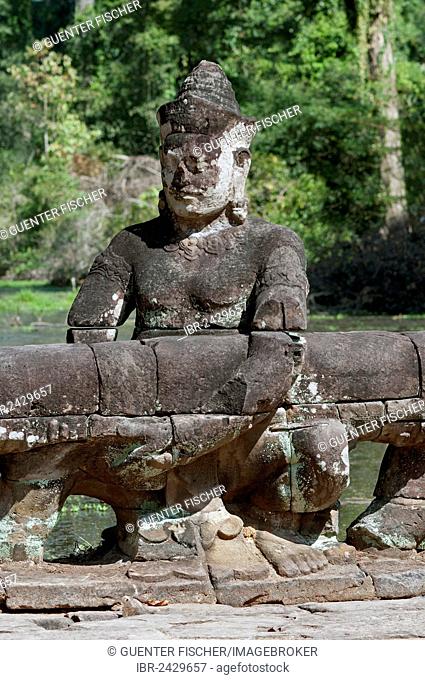 Asura statue bearing the giant snake Naga, on the balustrade of the causeway to the Preah Khan Temple, Angkor, Siem Reap, Cambodia, Southeast Asia