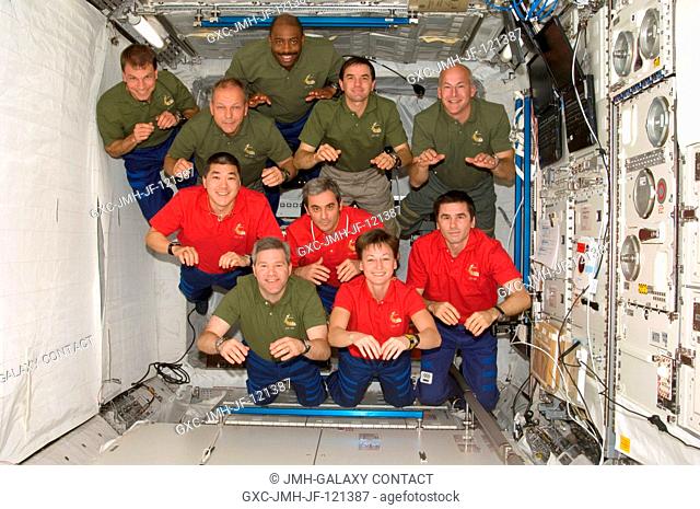 STS-122 and Expedition 16 crewmembers pose for a group photo following a joint news conference in the Columbus laboratory of the International Space Station...