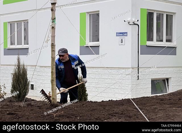 RUSSIA, MARIUPOL - MARCH 21, 2023: Landscaping an area of newly built apartment blocks in Prospekt Lenina Street. The Donetsk People's Republic became part of...