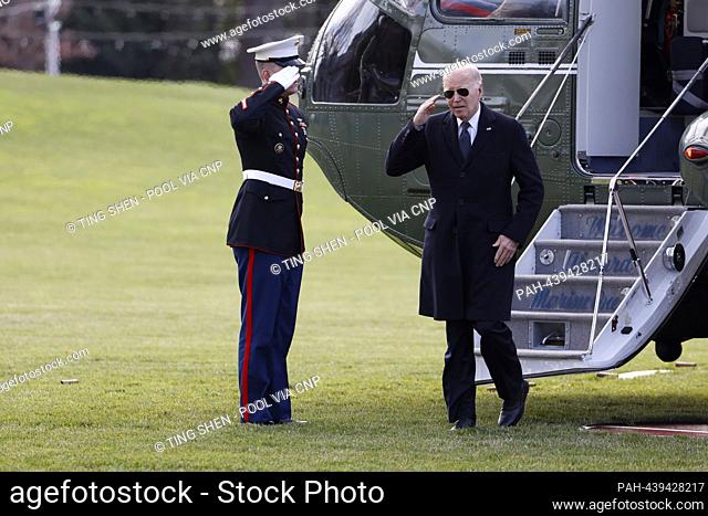 United States President Joe Biden salutes the Marine Guard as he disembarks Marine One on the South Lawn of the White House in Washington, DC, US, on Tuesday