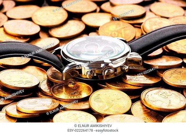 Time is money concept with watch and coins