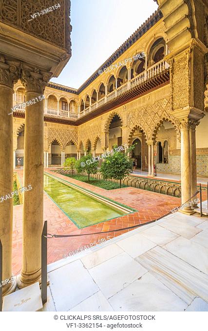 Patio de las Doncellas, a decorated courtyard and pool in typical Mudejar architecteure. Real Alcazar, Seville, Andalusia, Spain
