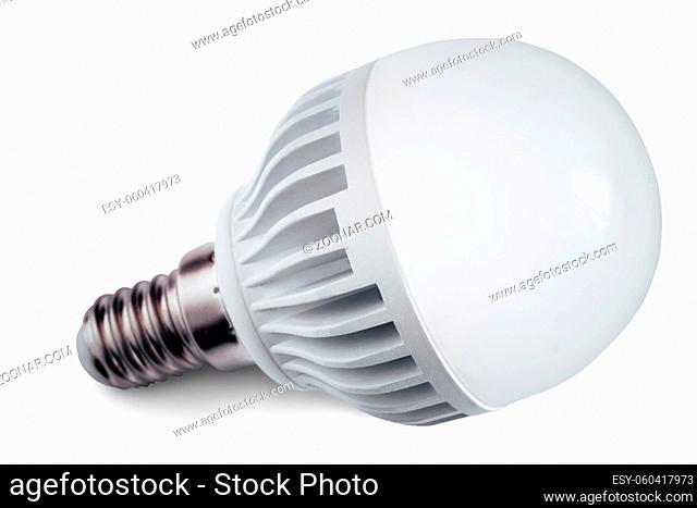 A small energy-saving lamp is lit on a bright background. The concept of energy saving . Isolated on white background