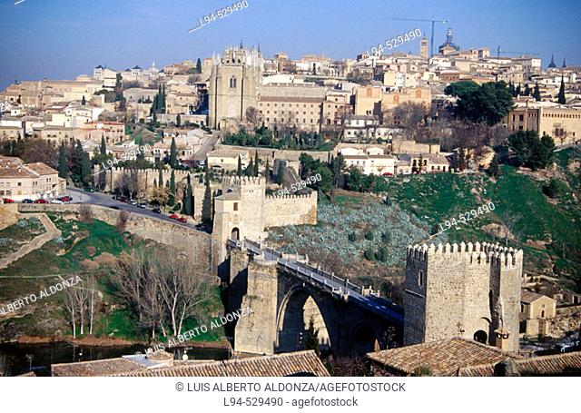 San Martín gate and bridge and Monastery of San Juan de los Reyes on the top of the Toledo old fortified town. Castilla-La Mancha, Spain
