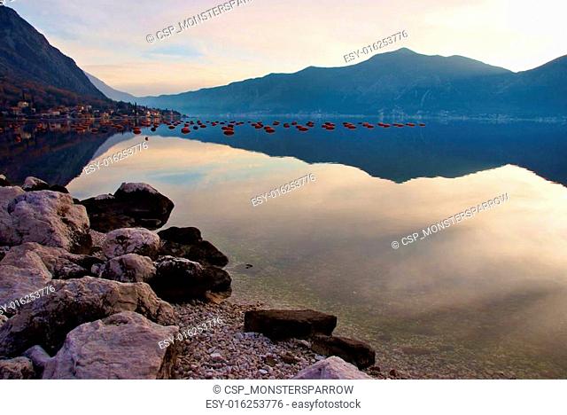 waterscape with mountain and mussel farm with perfect mirror image