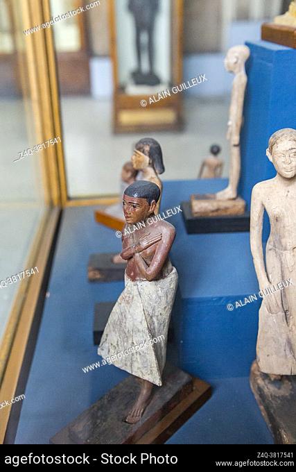 Cairo, Egyptian Museum, statuette of Iby, in wood. He's got short hair, a loin cloth, and crossed arms