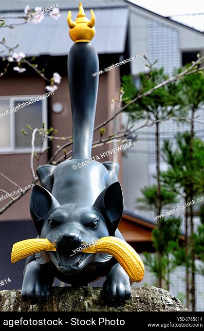 Statuette of Kitsune - Messenger-fox, entrance to Fushimi Inari-taisha Shrine, head shrine of Inari located in Fushimi-ku, Kyoto, Kansai Region, Japan