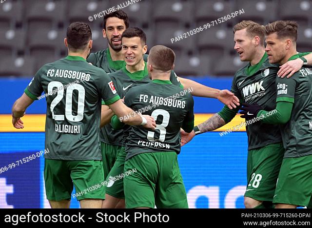 06 March 2021, Berlin: Football: Bundesliga, Hertha BSC - FC Augsburg, Matchday 24 at the Olympiastadion. Augsburg's players celebrate the goal scored by...